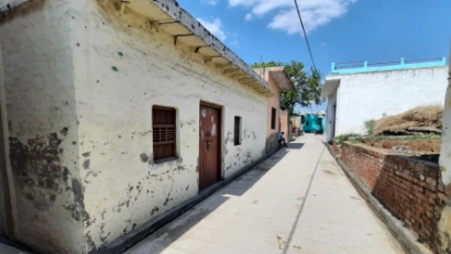 Image showcasing a rural village landscape with homes, greenery, and community spaces reflecting traditional village life.