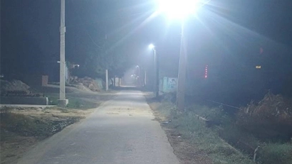 Image depicting a vibrant rural village with improved infrastructure and active community life.